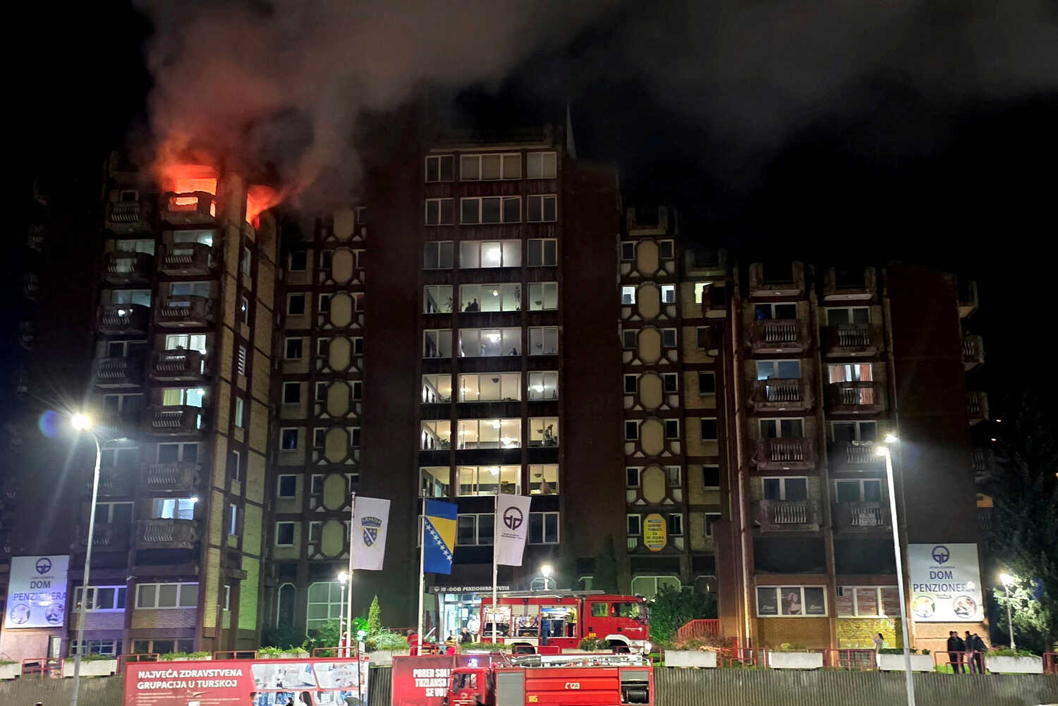 A tower with fire blazing out of two upper-story windows. 